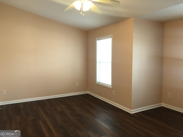 1938 Dilcrest Dr, Duluth, GA 30096 - empty room with dark wood-style flooring, ceiling fan, and baseboards