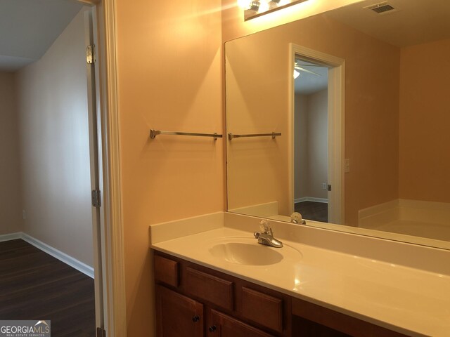 1938 Dilcrest Dr, Duluth, GA 30096 - bathroom featuring vanity, wood finished floors, and baseboards