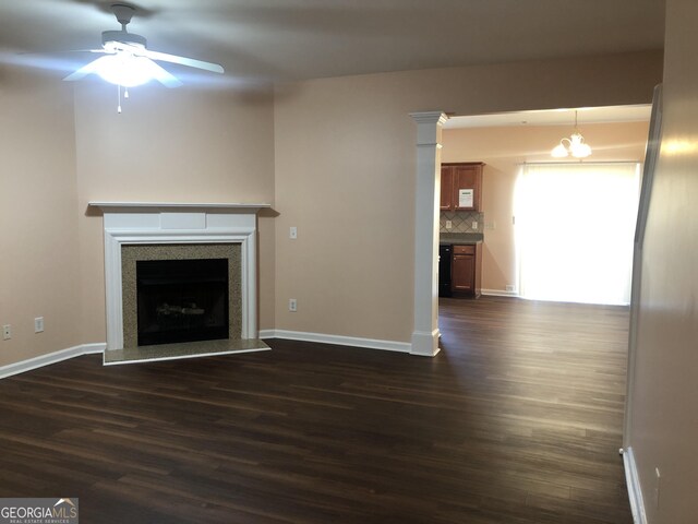 1938 Dilcrest Dr, Duluth, GA 30096 - unfurnished living room with dark wood-style floors, a ceiling fan, a fireplace with raised hearth, and baseboards