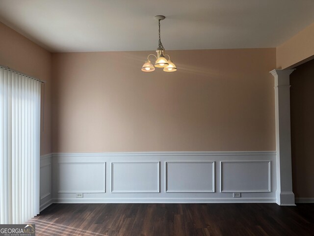 1938 Dilcrest Dr, Duluth, GA 30096 - unfurnished room featuring a chandelier, ornate columns, wainscoting, and dark wood-type flooring