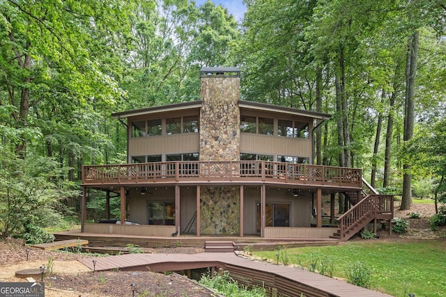 9020 Lakeview Pkwy, Villa Rica, GA 30180 - back of house with a wooden deck, a chimney, stairway, a sunroom, and a yard