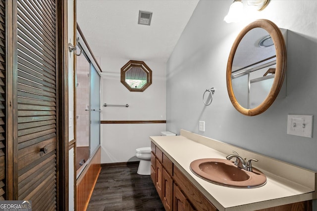 9020 Lakeview Pkwy, Villa Rica, GA 30180 - full bathroom with toilet, vanity, wood finished floors, bath / shower combo with glass door, and baseboards