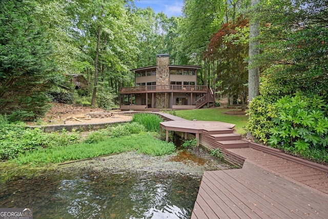 9020 Lakeview Pkwy, Villa Rica, GA 30180 - rear view of house featuring a chimney, a deck, and stairs