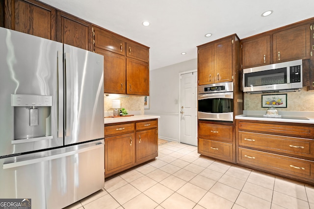 1260 Willeo Creek Dr, Roswell, GA 30075 - kitchen featuring appliances with stainless steel finishes, decorative backsplash, light countertops, light tile patterned flooring, and recessed lighting