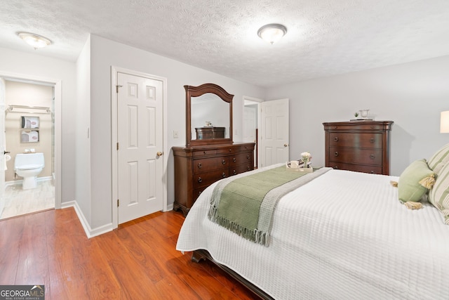 1260 Willeo Creek Dr, Roswell, GA 30075 - bedroom with wood finished floors and a textured ceiling