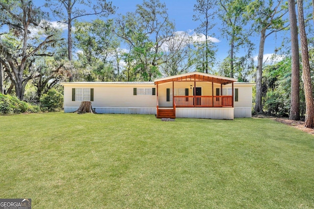 27 Pocahontas Rd, Midway, GA 31320 - view of front of house featuring a front lawn and a wooden deck