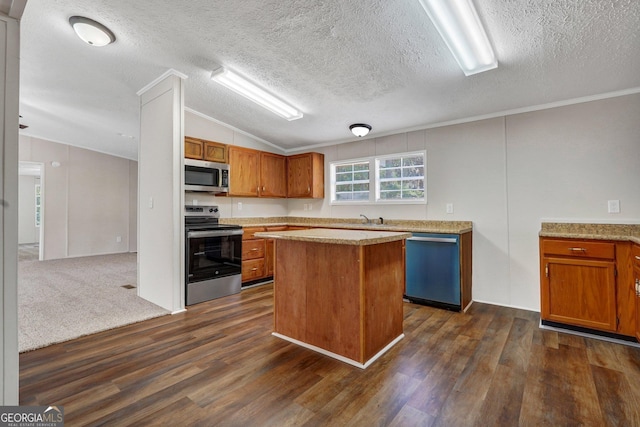 27 Pocahontas Rd, Midway, GA 31320 - kitchen featuring stainless steel appliances, dark wood-type flooring, lofted ceiling, brown cabinets, and a center island