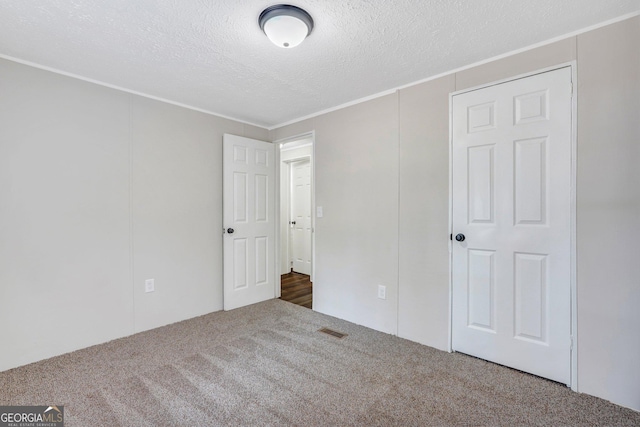27 Pocahontas Rd, Midway, GA 31320 - unfurnished bedroom featuring carpet floors, a textured ceiling, and crown molding