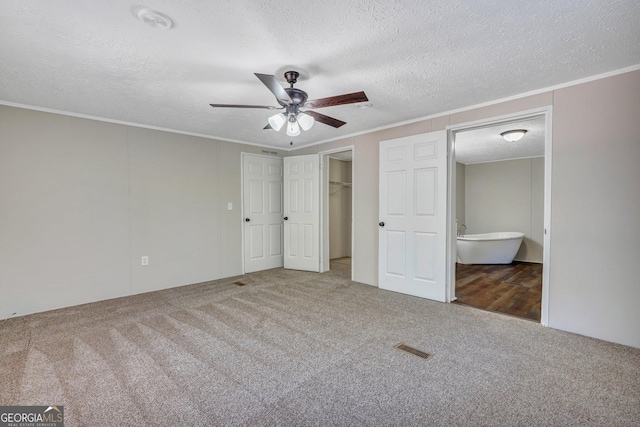 27 Pocahontas Rd, Midway, GA 31320 - unfurnished bedroom featuring carpet, ensuite bath, ornamental molding, a textured ceiling, and ceiling fan