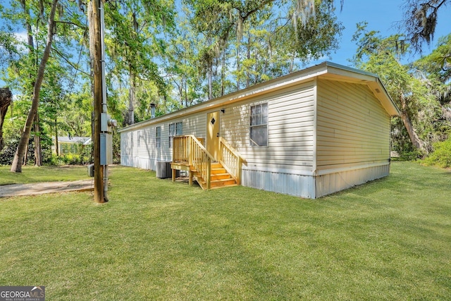 27 Pocahontas Rd, Midway, GA 31320 - manufactured / mobile home with a front lawn and central air condition unit