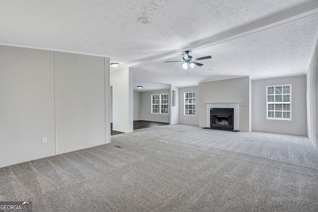 27 Pocahontas Rd, Midway, GA 31320 - unfurnished living room with carpet, a ceiling fan, a fireplace with raised hearth, a textured ceiling, and vaulted ceiling