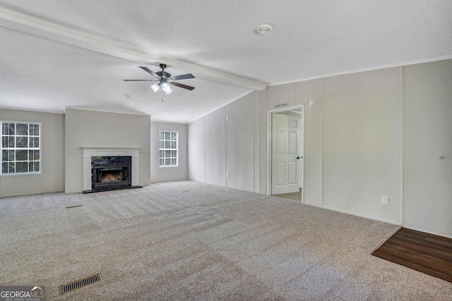 27 Pocahontas Rd, Midway, GA 31320 - unfurnished living room featuring a textured ceiling, carpet flooring, a ceiling fan, and a premium fireplace