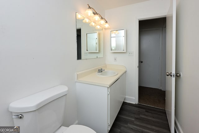 1309 Newton Rd, Albany, GA 31701 - half bathroom with toilet, wood finished floors, vanity, and baseboards
