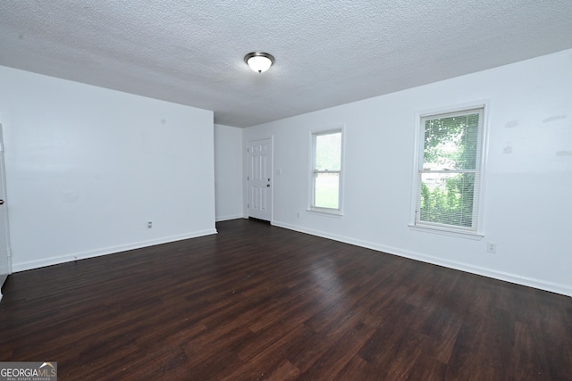 1309 Newton Rd, Albany, GA 31701 - unfurnished room with dark wood-type flooring, baseboards, and a textured ceiling