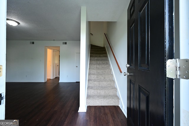 1309 Newton Rd, Albany, GA 31701 - stairs featuring wood finished floors, baseboards, and a textured ceiling