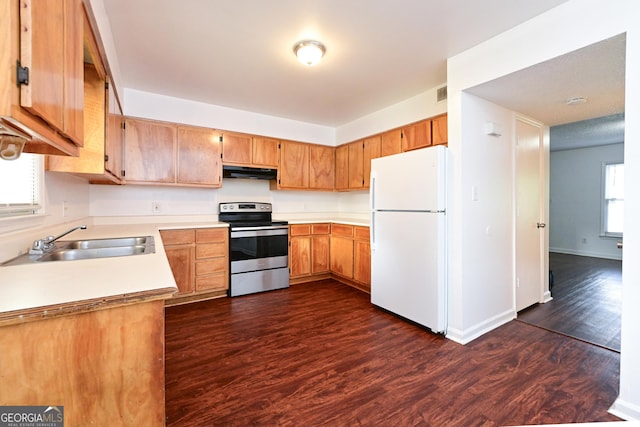 1309 Newton Rd, Albany, GA 31701 - kitchen with freestanding refrigerator, stainless steel electric range oven, a sink, under cabinet range hood, and dark wood finished floors