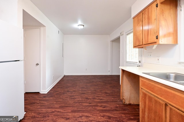 1309 Newton Rd, Albany, GA 31701 - kitchen with freestanding refrigerator, dark wood-style flooring, light countertops, and baseboards