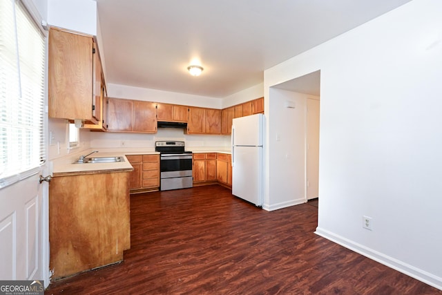 1309 Newton Rd, Albany, GA 31701 - kitchen with stainless steel range with electric cooktop, freestanding refrigerator, a sink, light countertops, and dark wood finished floors