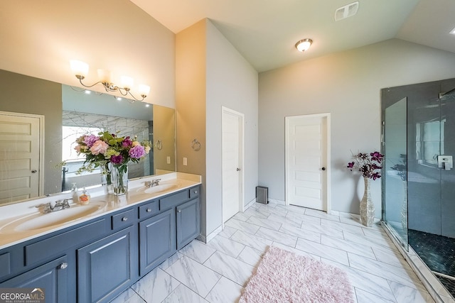 full bathroom with a shower stall, high vaulted ceiling, double vanity, and marble finish flooring