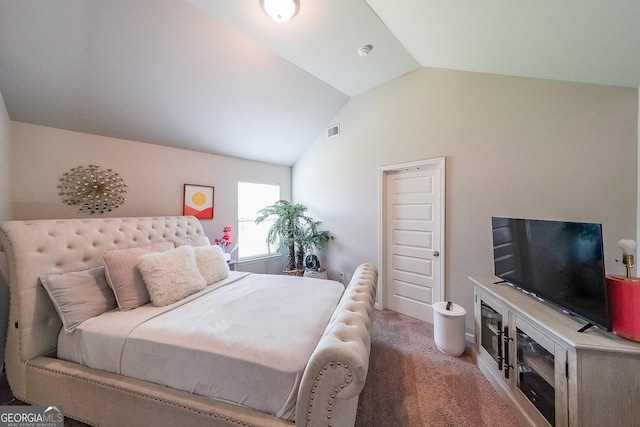bedroom with lofted ceiling and light colored carpet