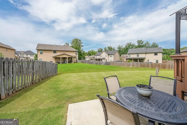 view of yard with a residential view, a patio area, and outdoor dining space