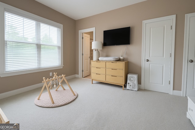 sitting room with light carpet and baseboards