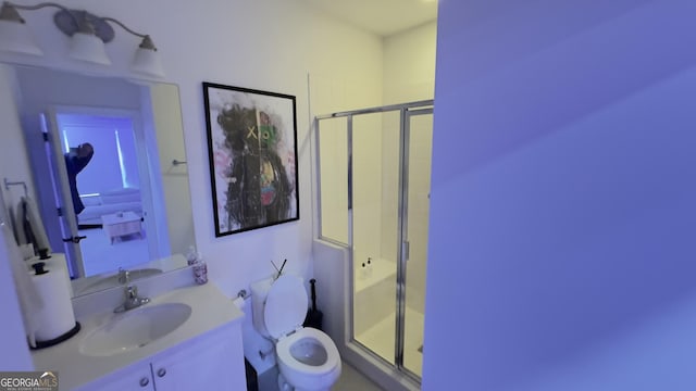 full bath with a stall shower, vanity, and toilet