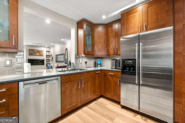 1141 Moorestown Cir, Decatur, GA 30033 - kitchen featuring stainless steel appliances, light wood-type flooring, decorative backsplash, brown cabinets, and recessed lighting