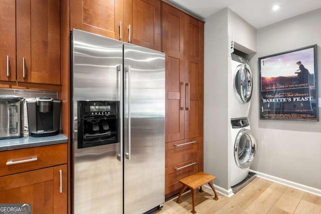 1141 Moorestown Cir, Decatur, GA 30033 - kitchen with high quality fridge, stacked washing machine and dryer, light wood-type flooring, brown cabinetry, and recessed lighting