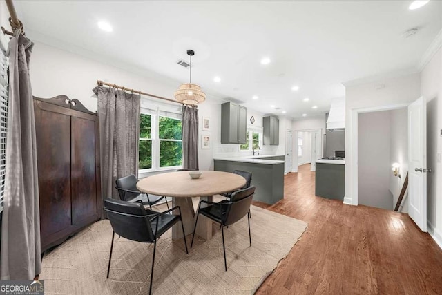 2324 Oakview Rd NE, Atlanta, GA 30317 - dining room with light wood-style flooring, ornamental molding, and recessed lighting