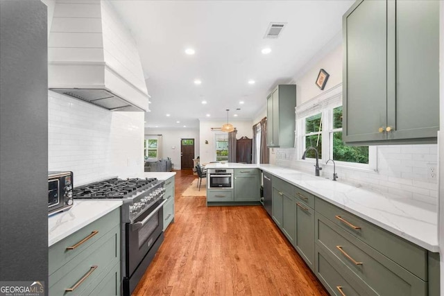 2324 Oakview Rd NE, Atlanta, GA 30317 - kitchen featuring green cabinets, appliances with stainless steel finishes, custom exhaust hood, a sink, and decorative backsplash