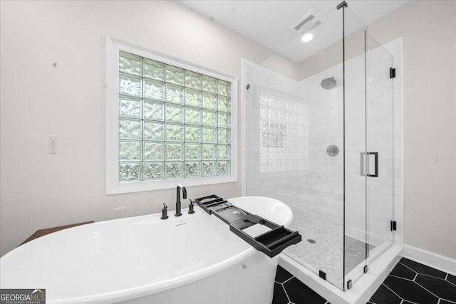 2324 Oakview Rd NE, Atlanta, GA 30317 - bathroom with a freestanding bath, a stall shower, and tile patterned floors