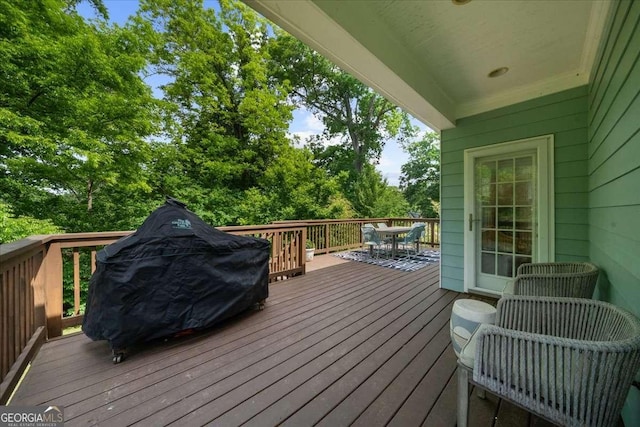 2324 Oakview Rd NE, Atlanta, GA 30317 - wooden terrace featuring outdoor dining space, view of wooded area, and a grill