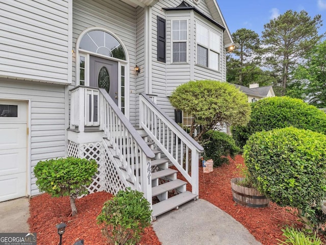 doorway to property with a garage
