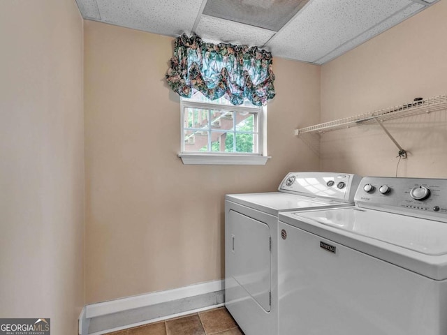 washroom featuring washer and dryer, baseboards, and tile patterned floors