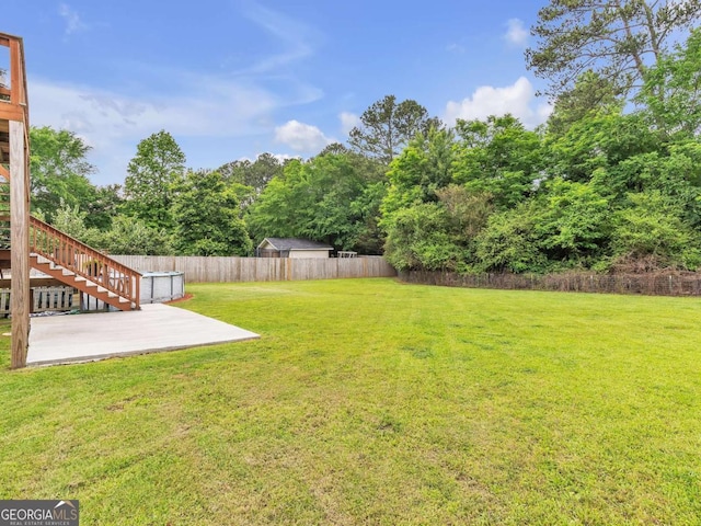 view of yard featuring a patio area and stairs