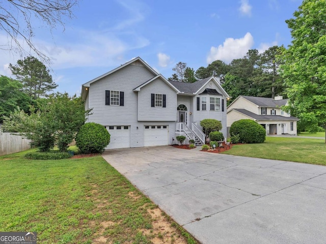 bi-level home featuring a garage and concrete driveway