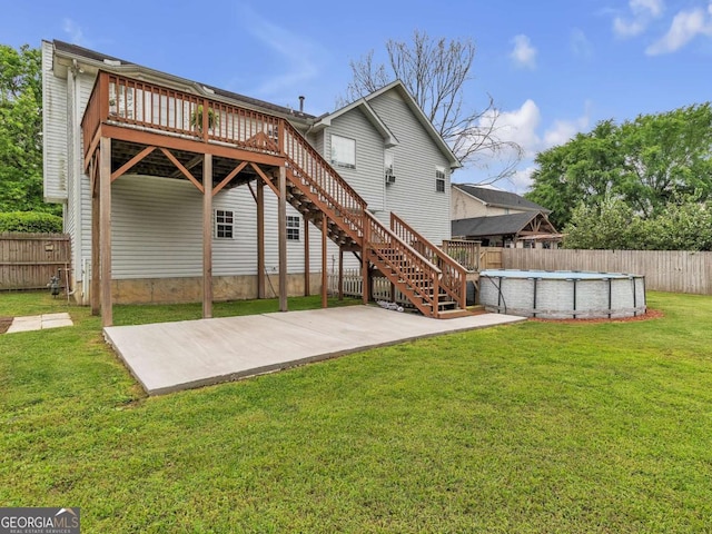 rear view of property featuring stairway and a wooden deck