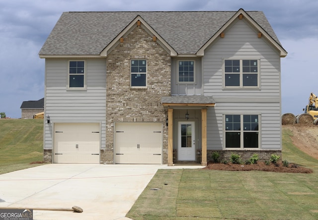 809 Brittany, Nicole Bonaire, GA 31005 - view of front of home with concrete driveway, a front yard, an attached garage, roof with shingles, and brick siding