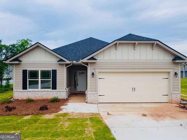craftsman-style home with roof with shingles, an attached garage, driveway, board and batten siding, and brick siding