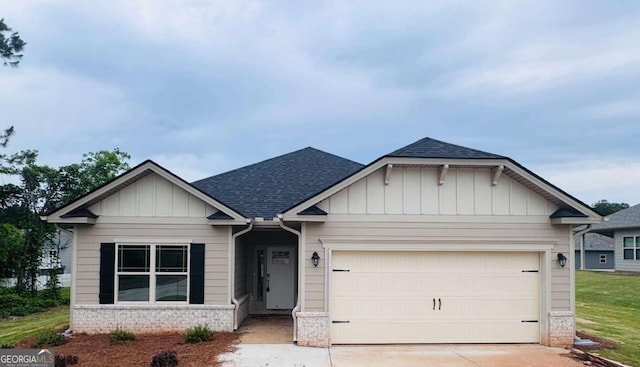 craftsman inspired home featuring a shingled roof, driveway, board and batten siding, a garage, and brick siding