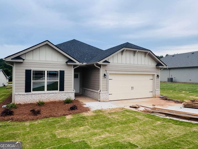 craftsman inspired home featuring an attached garage, board and batten siding, a front yard, and driveway
