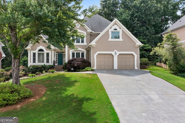 1377 Downington Ln NW, Acworth, GA 30101 - view of front facade with driveway, a front lawn, stucco siding, and a garage