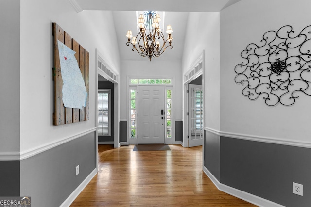 1377 Downington Ln NW, Acworth, GA 30101 - entryway featuring light wood finished floors, a chandelier, and baseboards