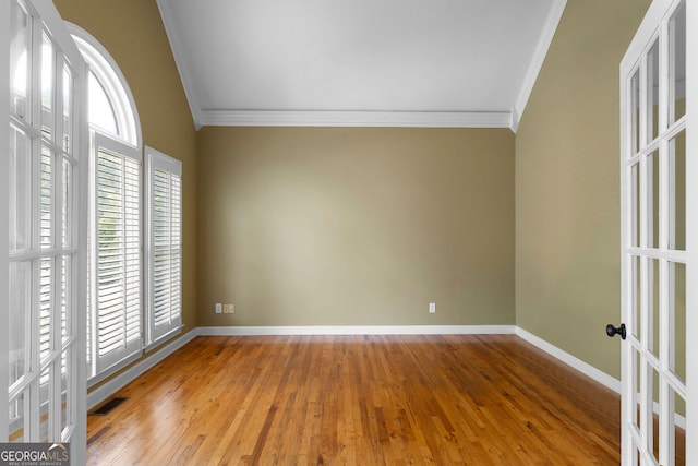 1377 Downington Ln NW, Acworth, GA 30101 - unfurnished bedroom featuring crown molding, baseboards, wood finished floors, french doors, and lofted ceiling