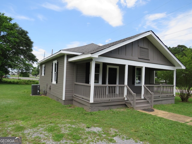 2 4th St, Cedartown, GA 30125 - view of front facade featuring board and batten siding, covered porch, a front yard, and cooling unit