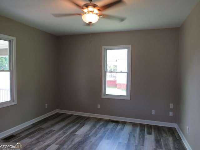 2 4th St, Cedartown, GA 30125 - empty room with plenty of natural light, dark wood-type flooring, a ceiling fan, and baseboards