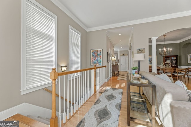 4298 Kingston Gate Cv, Chamblee, GA 30341 - corridor with arched walkways, a chandelier, light wood-style floors, crown molding, and baseboards