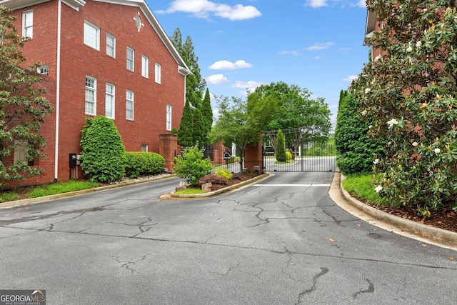4298 Kingston Gate Cv, Chamblee, GA 30341 - view of asphalt road with curbs, a gate, and a gated entry