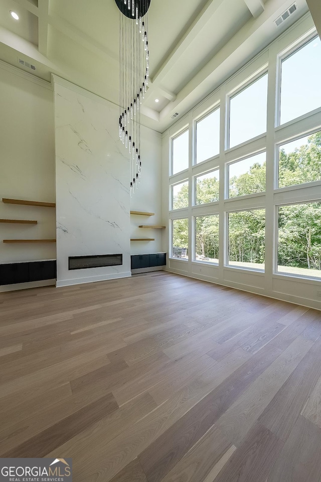 972 Auburn Rd, Dacula, GA 30019 - unfurnished living room featuring a high ceiling, a premium fireplace, wood finished floors, and recessed lighting